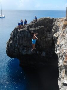 Cliff Jumping on Sombero, sail boat, blue ocean 